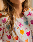 Close-up of our Albi Long Sleeve Pyjama, featuring colorful heart prints and Arabic words of love on soft, cozy fabric.