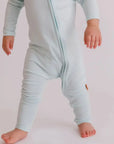 A baby wearing our Reef Pyjama, moving freely in its ultra-soft, breathable bamboo fabric made for comfort and play.