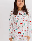 A smiling girl wearing our Christmas Long Sleeve Kids Pyjama, featuring Levant-inspired festive patterns that capture the warmth of the holiday season.