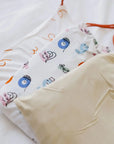 Our CloudSoft™ Crib Sheet Set — a trio of ultra-soft bamboo sheets blending cultural charm and calming neutral tones for a dreamy nursery.