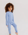 A young child wearing the **Bahry Pyjama**, a soft light-blue long-sleeve sleep set made for comfort and ease of movement.