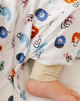 A cozy close-up of our Nohm Tanween Bedding Set, showing its soft bamboo fabric and charming Arabic-inspired prints.