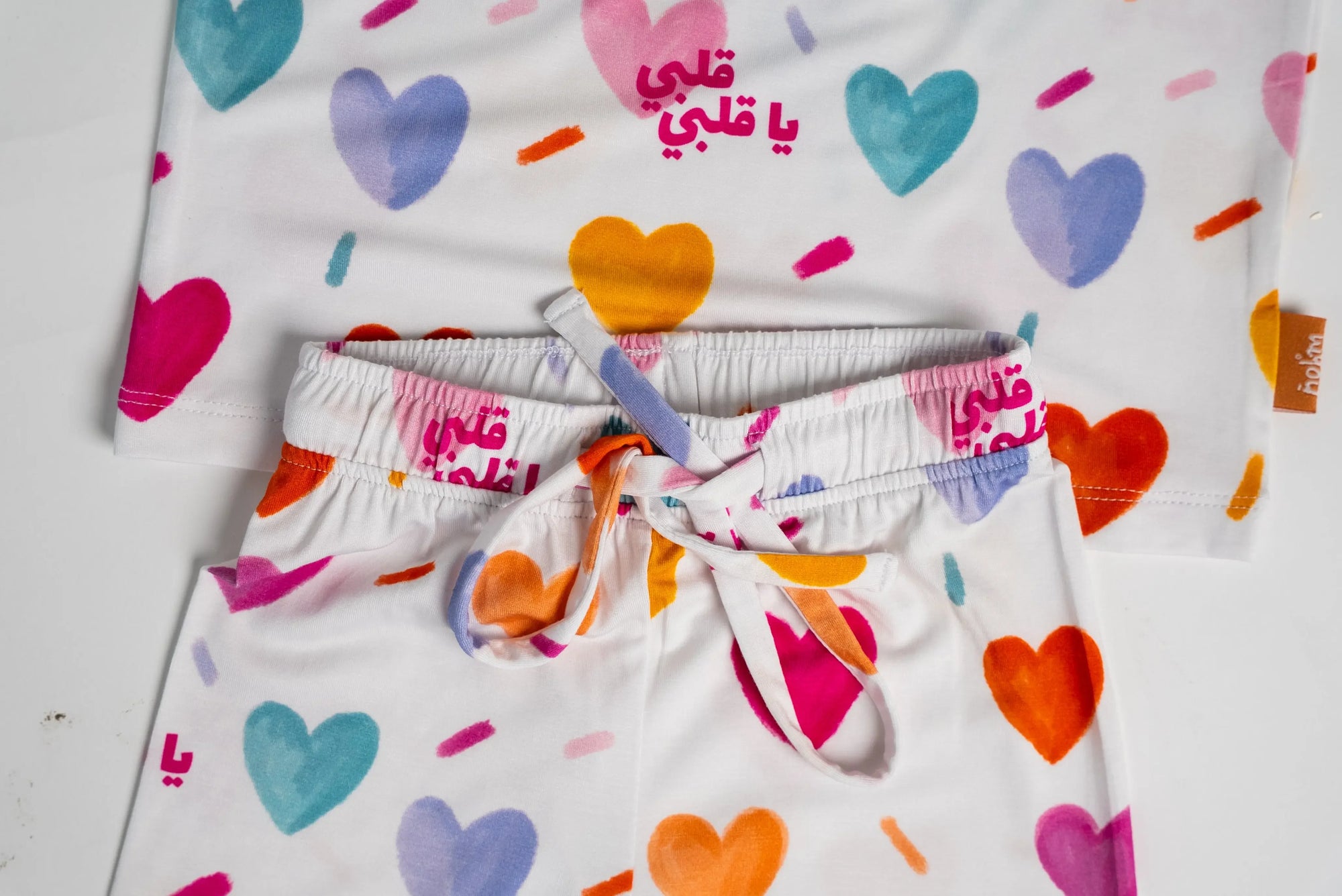 Close-up of our Albi Long Sleeve Pyjama, featuring a playful heart print and the Arabic phrase &quot;يا قلبي&quot; for a sweet bedtime touch.