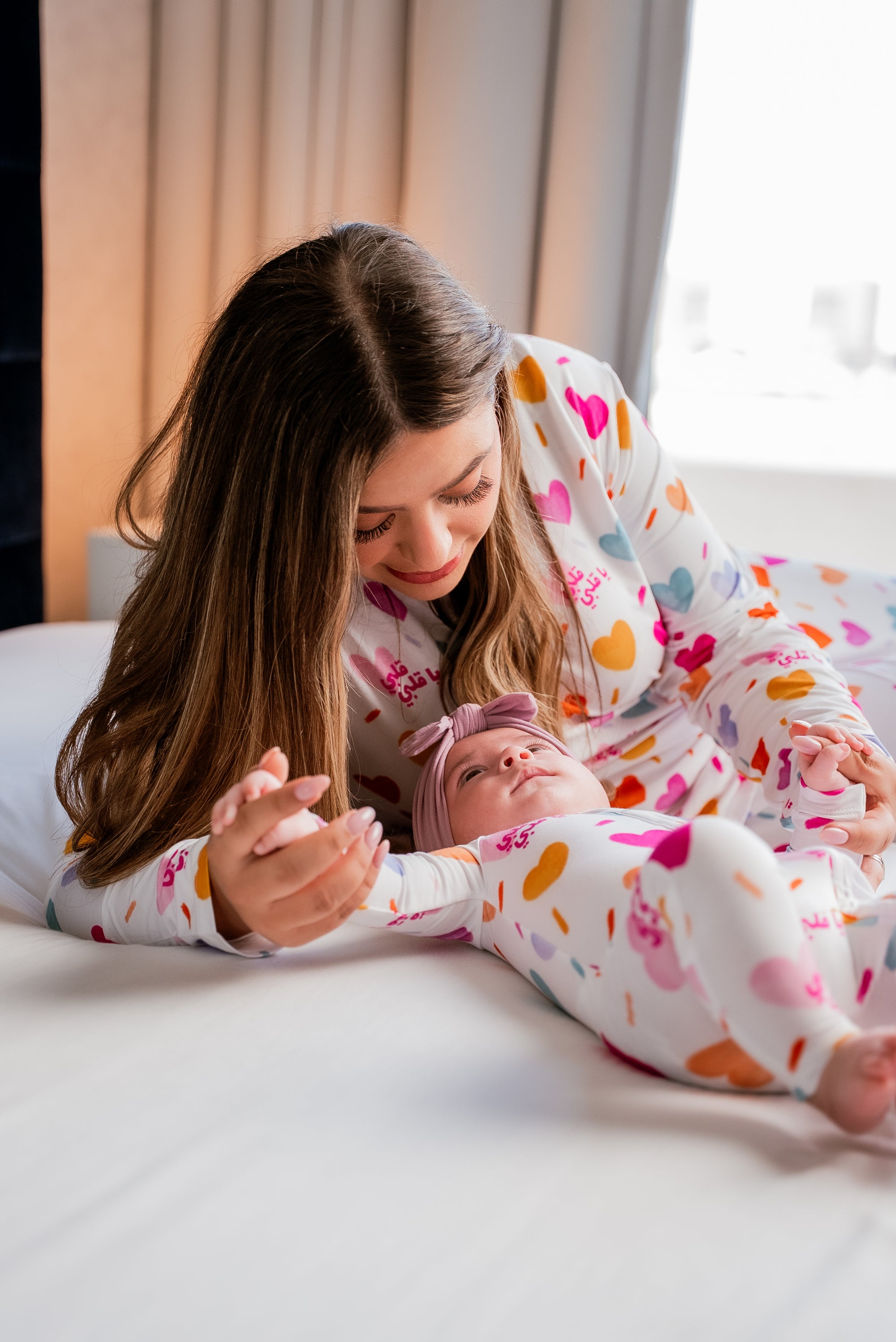 A mom and baby twinning in our Albi Pyjamas, sharing a sweet cuddle in matching heart-filled comfort.
