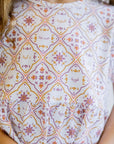A close-up of our Arabesque Dress, featuring intricate tile-inspired patterns and Arabic words celebrating strength and grace.