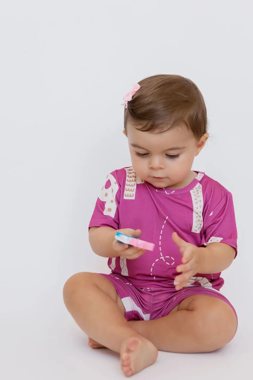 A little one playing while wearing our Arqam Short Sleeve Pyjama — a vibrant bamboo set featuring playful Arabic numbers for comfy, curiosity-filled days.