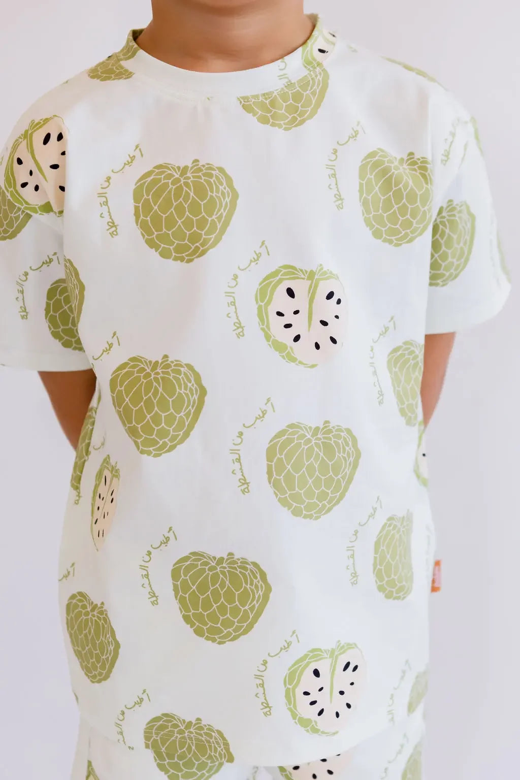 A close-up of our Ashta Loungewear set, showcasing the soft cotton fabric and playful annona fruit pattern.