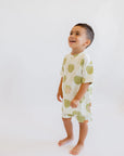 A cheerful boy laughing while wearing our Ashta Loungewear set, inspired by the playful charm of the annona fruit.