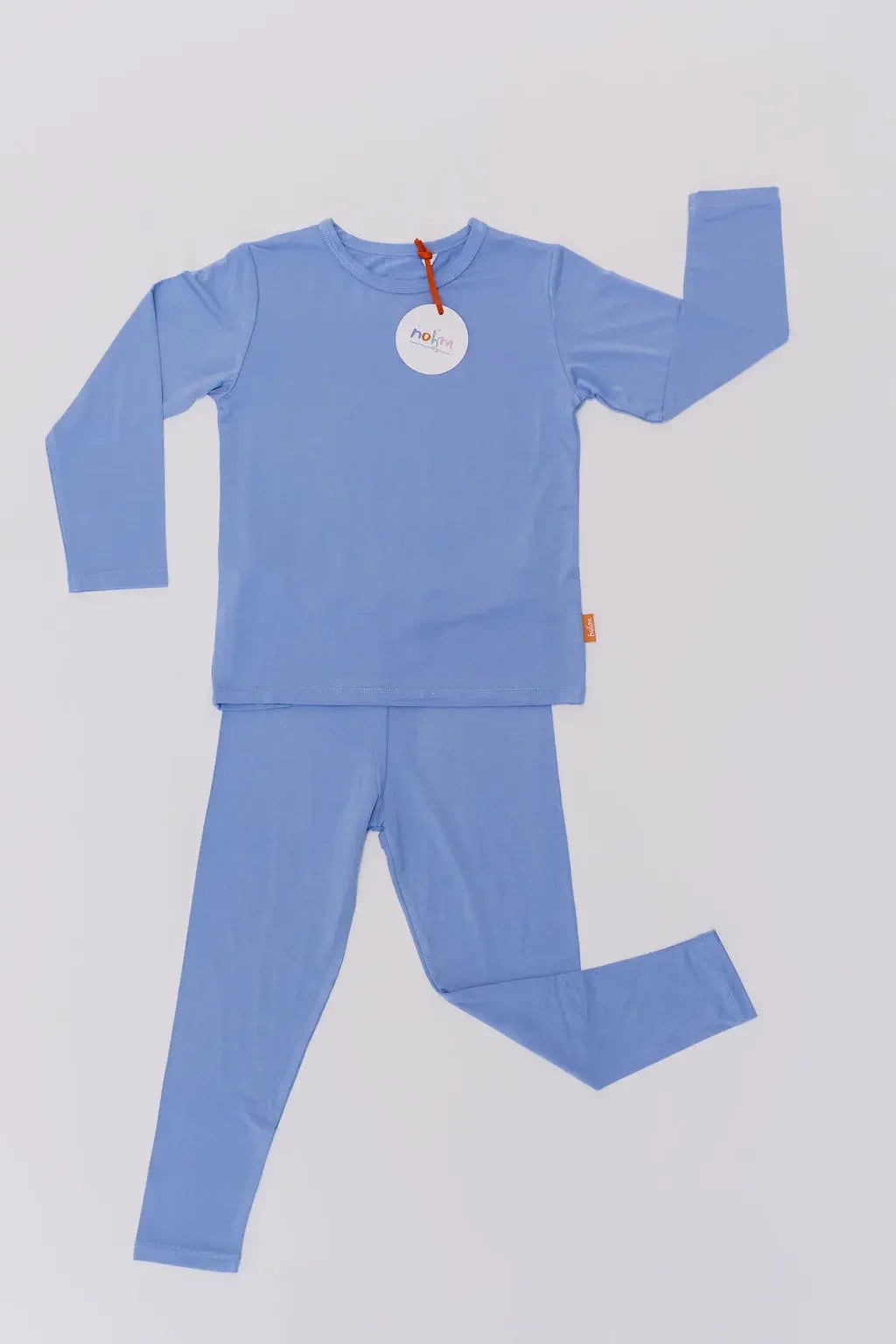Our Bahry Long Sleeve Kids Pyjama laid flat, showcasing the soft bamboo fabric and minimalist blue design made for ultimate comfort.