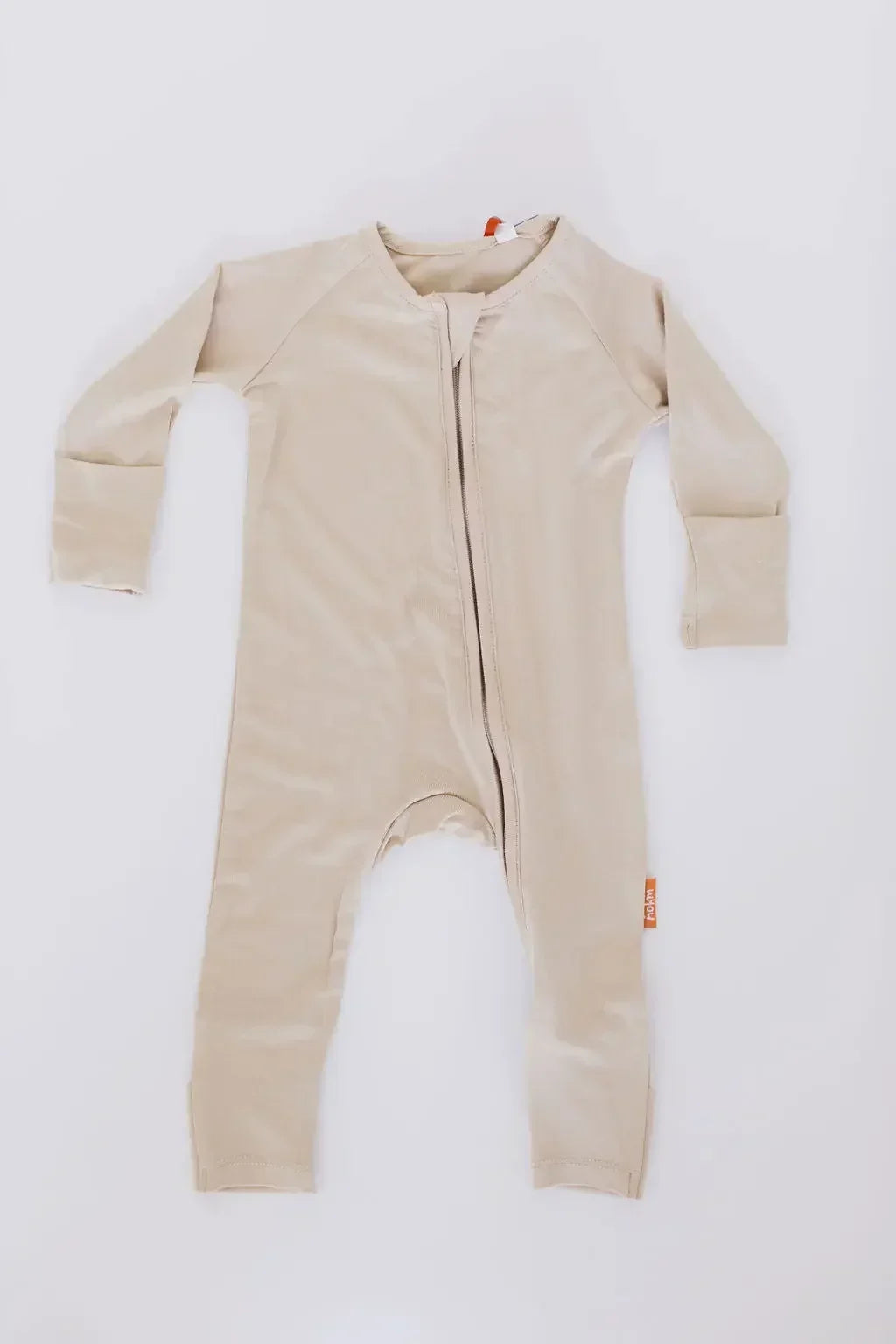 The **Ramly Baby Pyjama** from the **Grow with Nohm: Gift Set**, a beige bamboo one-piece featuring a front zipper and foldable cuffs for a cozy, adjustable fit.
