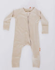 The **Ramly Baby Pyjama** from the **Grow with Nohm: Gift Set**, a beige bamboo one-piece featuring a front zipper and foldable cuffs for a cozy, adjustable fit.
