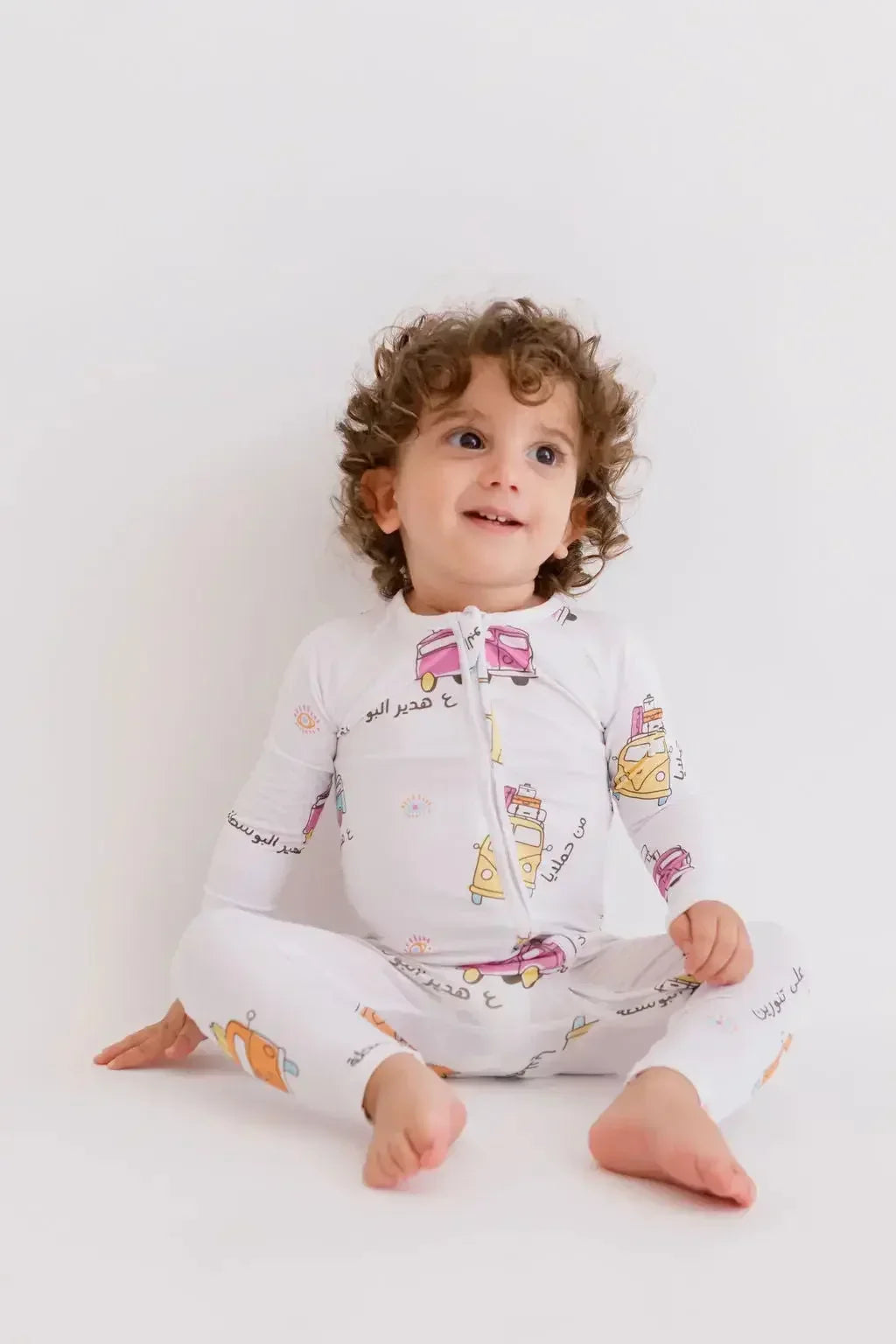 A baby wearing our Reef Pyjama, cozy in its timeless solid tone and buttery-soft bamboo fabric.