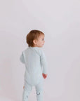 A baby wearing our Reef Pyjama, showing off its simple, gender-neutral design made for all-day comfort.