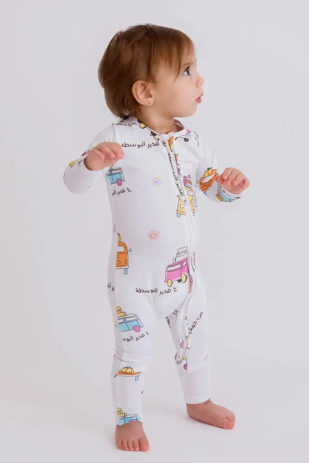A baby wearing our Bosta Pyjama, exploring freely in soft bamboo comfort and vibrant Lebanese-inspired prints.