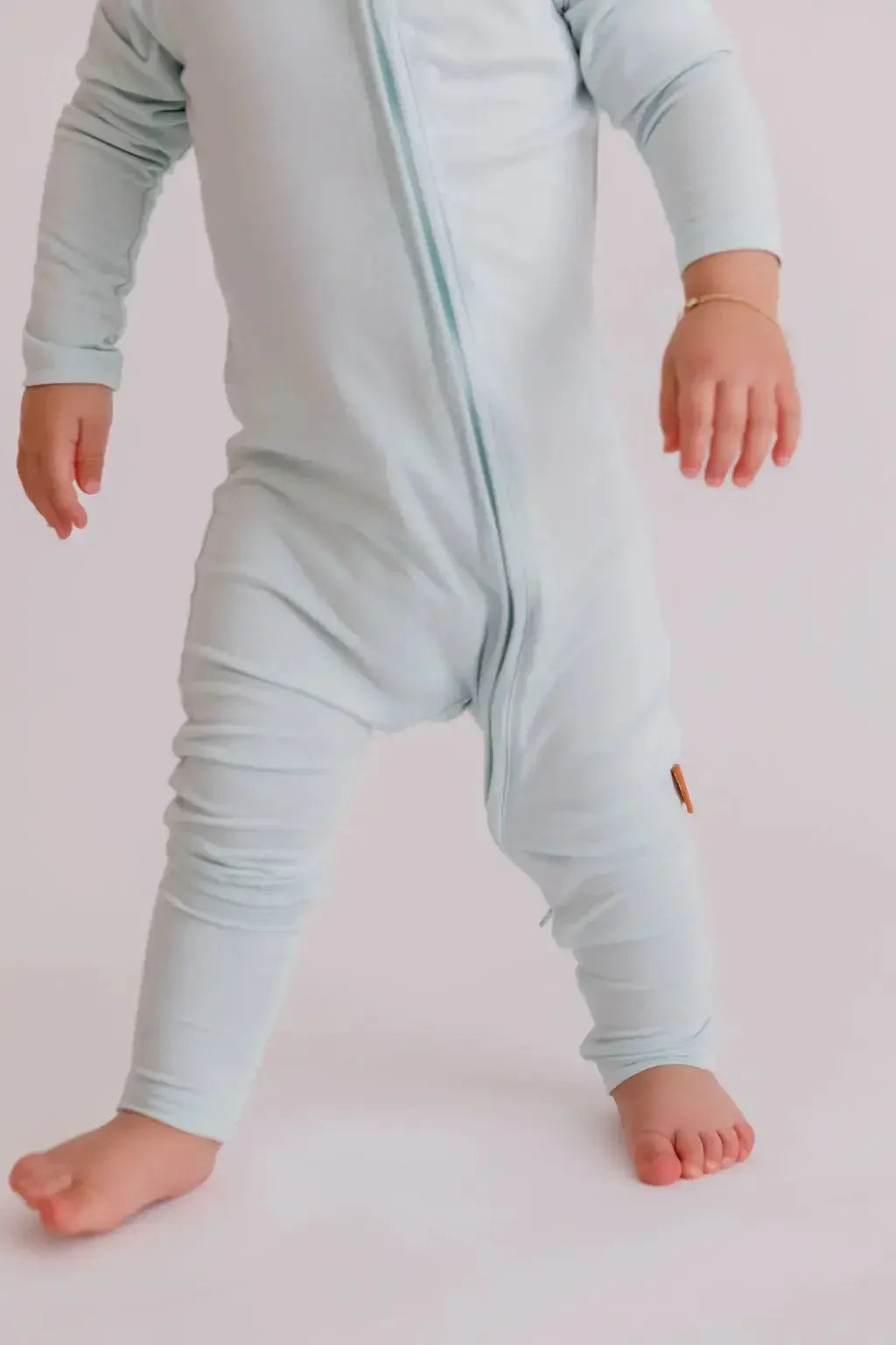 A baby wearing our Reef Pyjama, moving freely in its ultra-soft, breathable bamboo fabric made for comfort and play.
