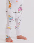 A baby wearing our Bosta Pyjama, featuring colorful Lebanese bus prints for a fun and meaningful bedtime look.
