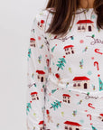 A close-up of our Christmas Long Sleeve Kids Pyjama, highlighting the Levant-inspired festive print with stone houses, pine trees, and candy canes.