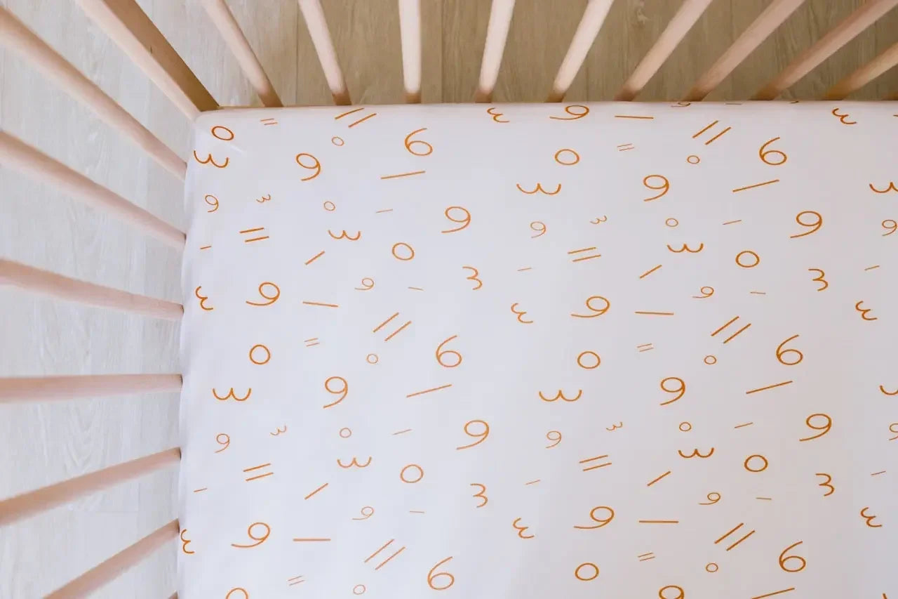 Harakat fitted crib sheet from Nohm store, stylish and cozy Arabic crib sheet, great for baby gifts in Dubai.