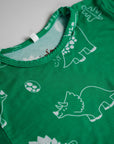 Close-up of our Dinosaur Pyjama top, highlighting the fun white dinosaur prints and soft green bamboo fabric.