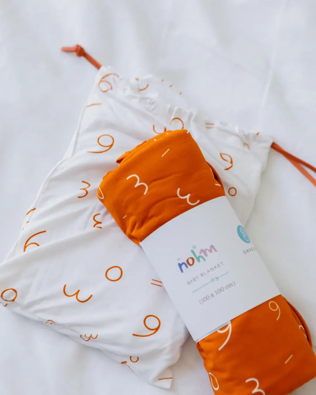 Our Nohm Harakat Bedding Set — a soft bamboo blanket and sheet duo adorned with playful Arabic harakat patterns for a cozy, cultural touch.