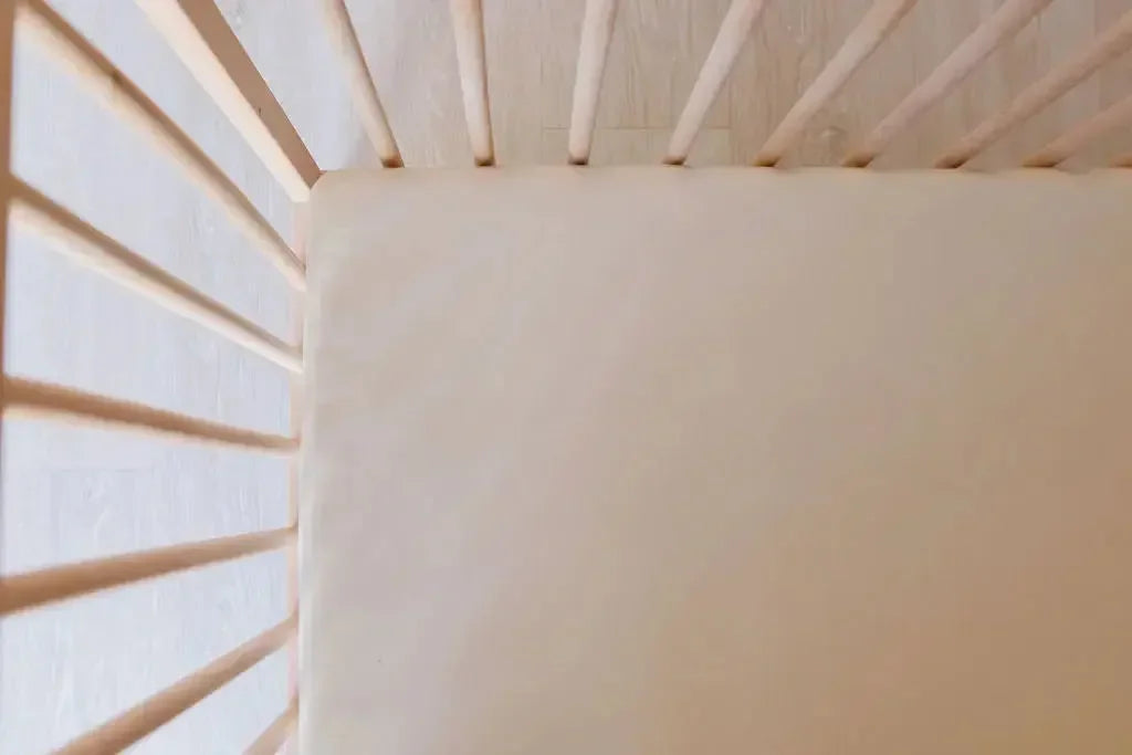 A close-up of our Nohm Ramly Crib Sheet, perfectly fitted for a snug and serene sleep space.