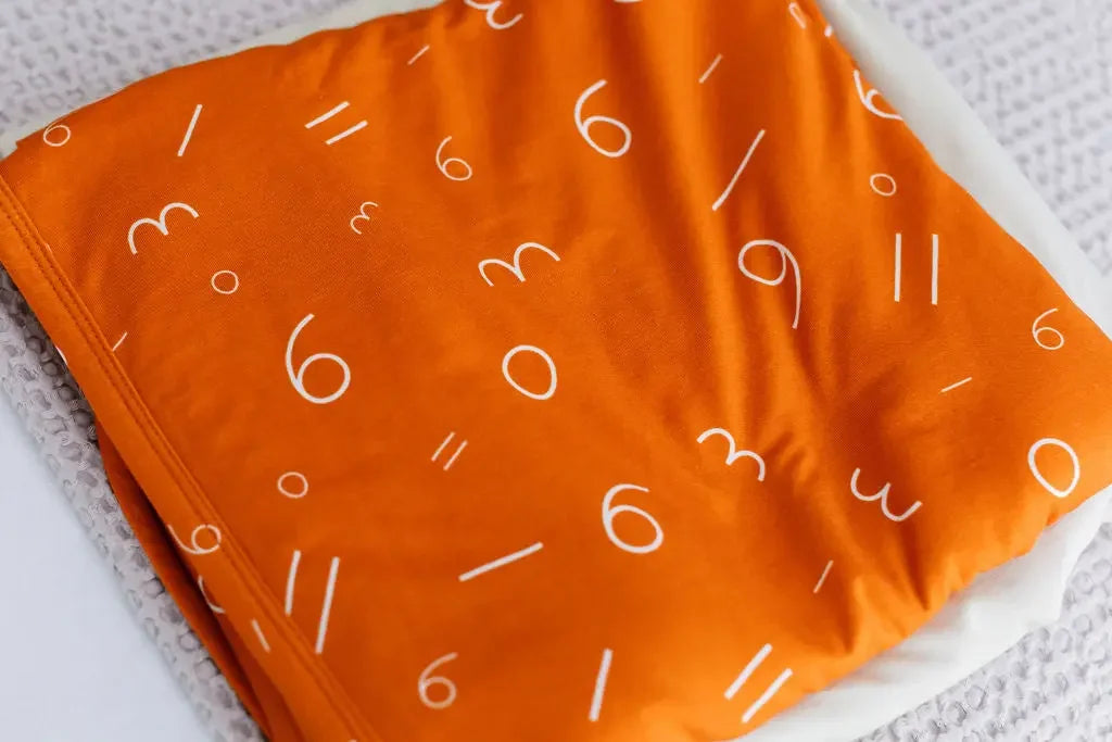 Harakat bamboo blanket from Nohm store, stylish and soft Arabic-inspired blanket, perfect for children and baby gifts in Dubai.