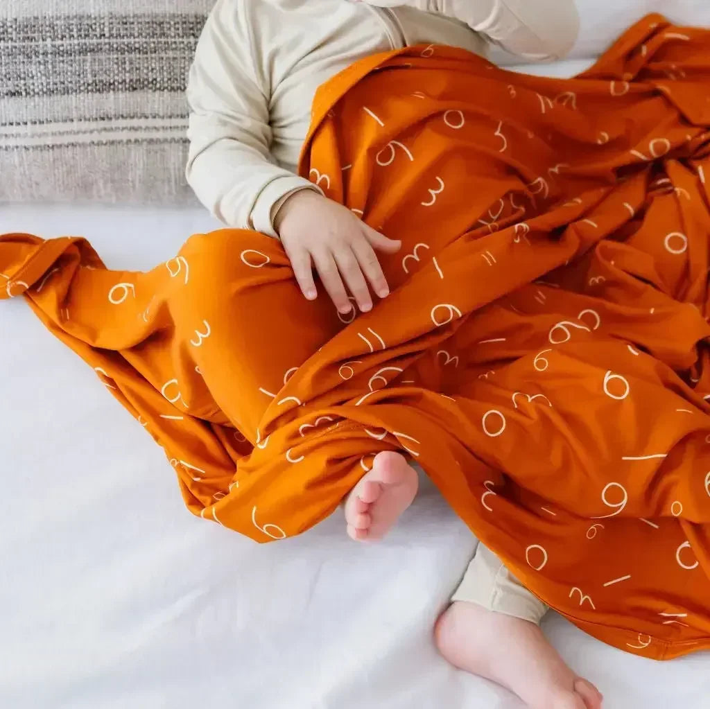 Harakat fitted crib sheet from Nohm store, stylish and cozy Arabic crib sheet, great for baby gifts in Dubai.
