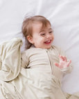 A happy baby snuggled in our Nohm Ramly Bedding Set, wrapped in the pure comfort of soft, breathable bamboo fabric.