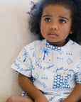 A thoughtful little girl sitting calmly while wearing our Saudi T-Shirt, proudly showcasing the “سعودي وأفتخر” design.
