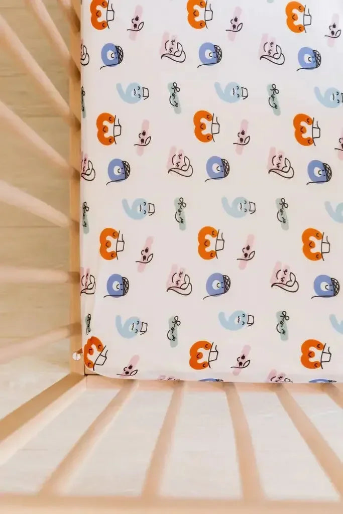 A close-up of our Nohm Tanween Crib Sheet, featuring soft bamboo fabric and playful Arabic-inspired prints for a cozy, cultural touch.