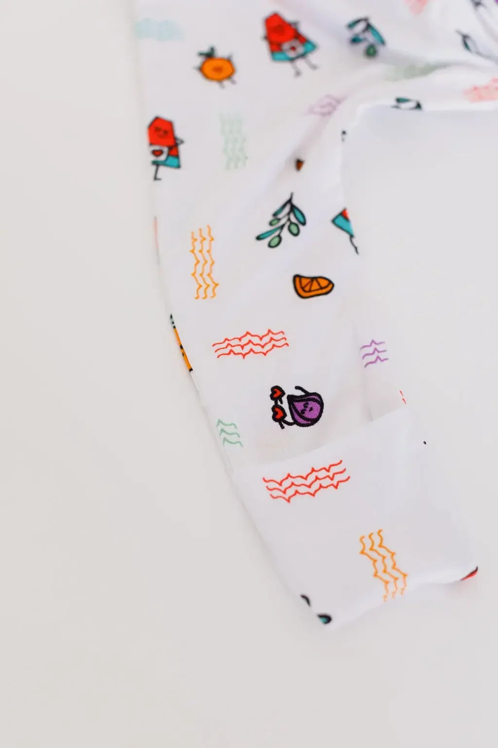 A close-up of the **Watermelon Pyjama** from the **Watermelon Bundle**, showing its colorful fruit-inspired pattern and soft, stretchy bamboo fabric with a foldable foot cover detail.
