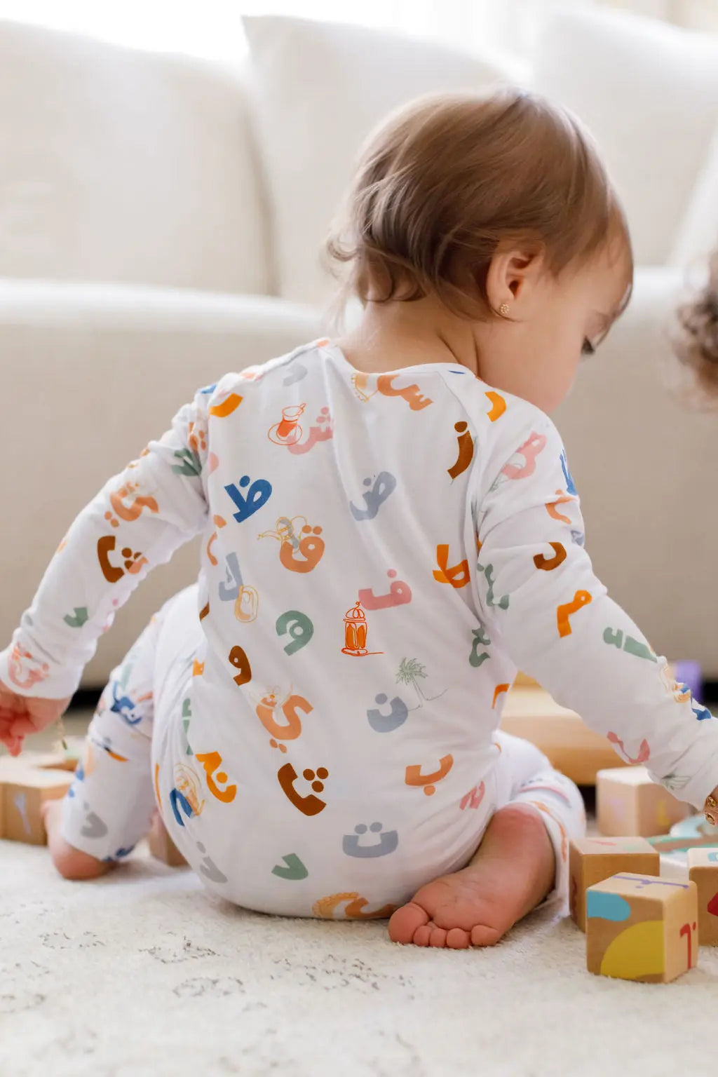 Huroof baby pyjama from Nohm store, Arabic letter-inspired pyjama, perfect for children and baby gifts in Dubai.