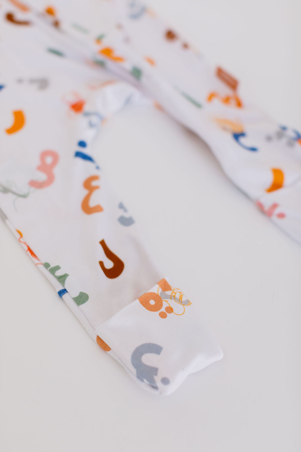 Huroof baby pyjama from Nohm store, Arabic letter-inspired pyjama, perfect for children and baby gifts in Dubai.